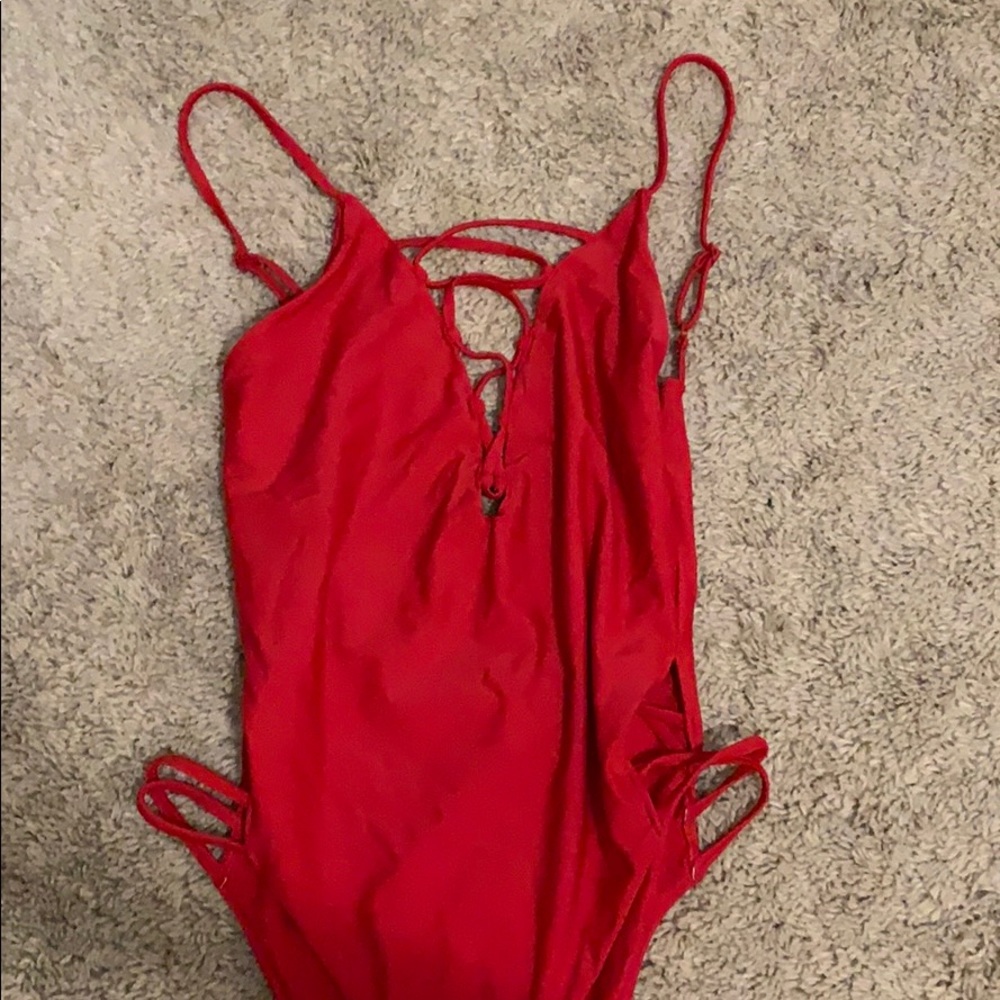 Tobi red one piece monokini with cut outs. Cheeky